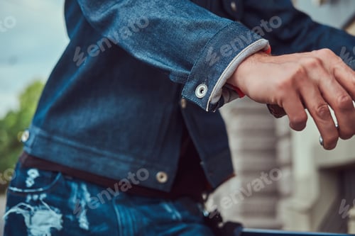 Preview: Cropped image of a fashionable man in stylish clothes walking with city bicycle on the street.