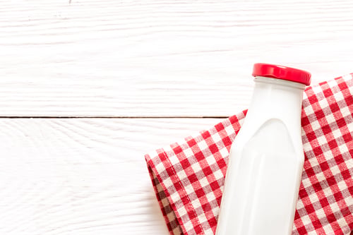 Preview: Bottle of milk on a wooden white background, flat lay.