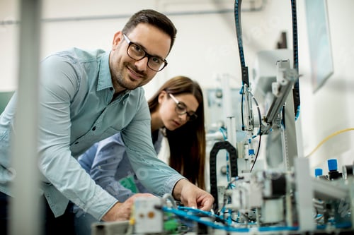 Preview: Young couple of students at robotics lab
