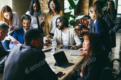 Preview: Multiracial business people working on sustainable innovation project - Focus on arabian man face