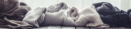 Preview: Knitted sweater on a wooden background