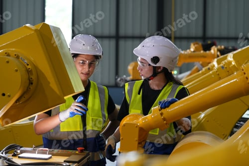 Preview: Robotics engineer working on maintenance of robotic arm in factory warehouse. Business technology.