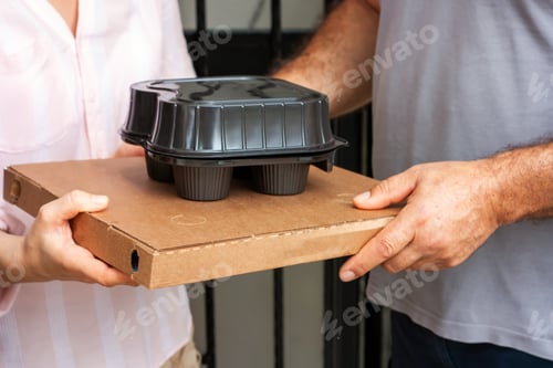 Preview: Food delivery service man with pizza cardboard and take delivering food to customer at doorway.