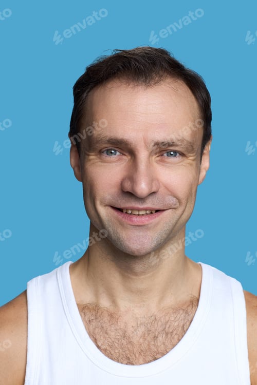 Preview: Portrait of Caucasian Middle Aged Man Smiling Against Blue Background