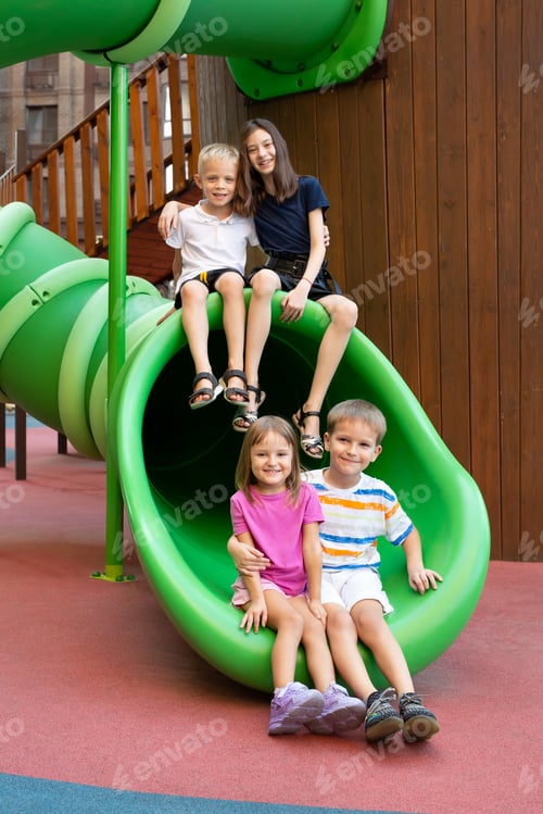 Preview: Children play on a modern playground, have fun and ride down the hill.