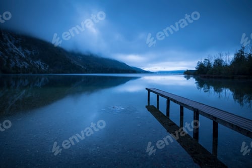 Preview: Tranquil lake at twilight with serene jetty