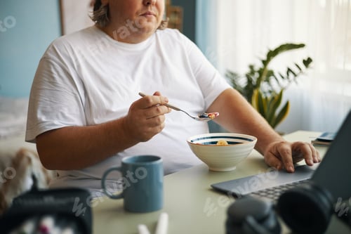 Preview: Eating Breakfast While Using Laptop in Morning Light