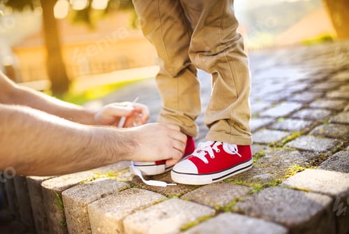 Preview: Father tying sons's shoes