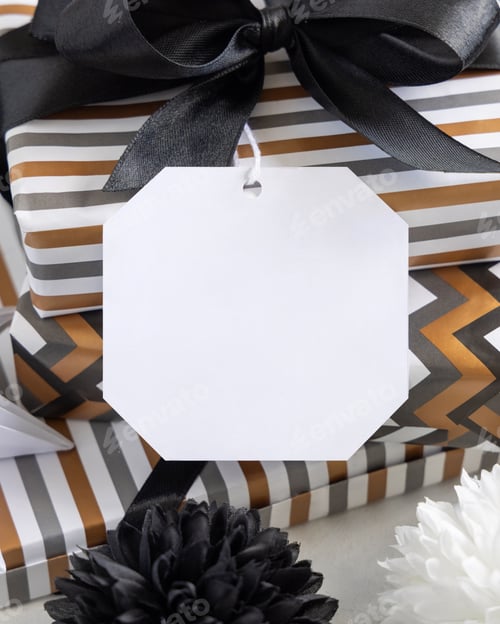 Preview: Wrapped present with blank gift tag and black bow close up, label Mockup