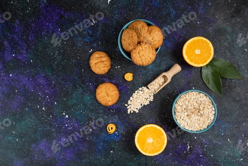 Preview: Wide angle photo of cookies with orange and oatmeal over space background