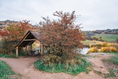 Preview: Small wooden gazebo among beautiful autumn trees on the Carpathian hills in Ukraine