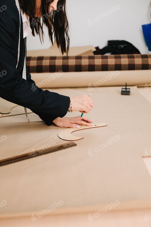 Preview: Garment patterns and drafting tools help designer plan precise fashion apparel.