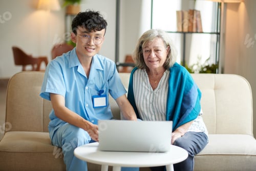 Preview: Caregiver and Senior Woman Using Laptop at Home
