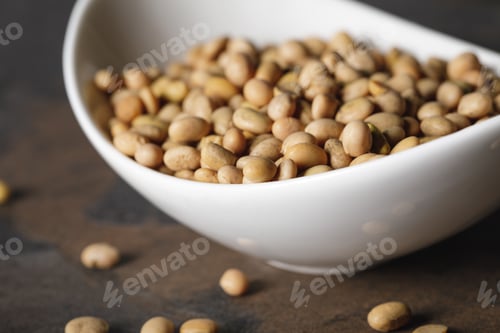 Preview: selective focus of soybean in white bowl on table