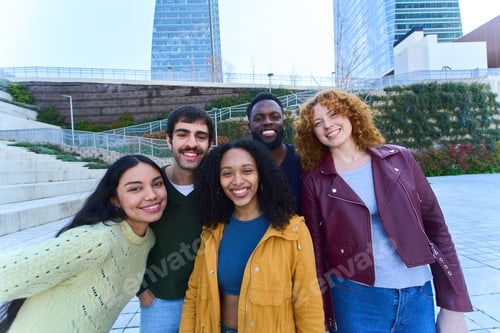 Preview: Happy multi ethnic students smiling together in a modern city park