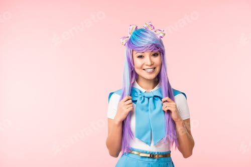Preview: Laughing asian anime girl touching hair isolated on pink