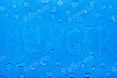 Preview: The word "hunger" is written with water droplets and water droplets on a blue smooth surface.