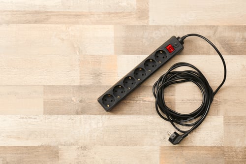Preview: Extension cord on wooden floor, top view with space for text. Electrician's equipment