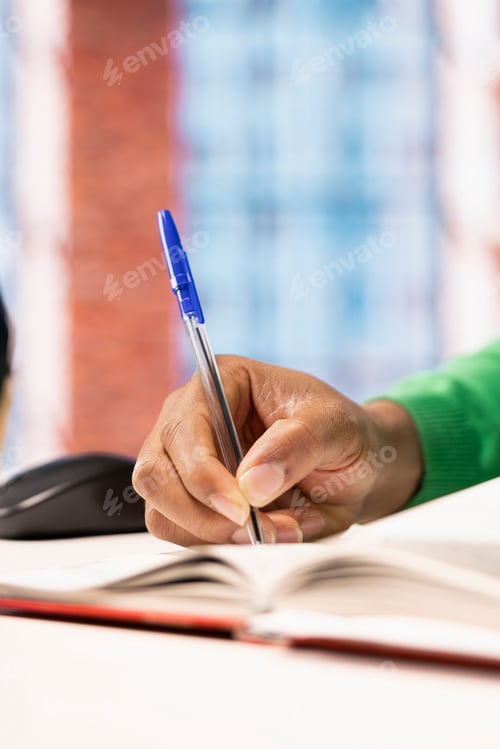 Preview: Close up of author writing book by hand in home office