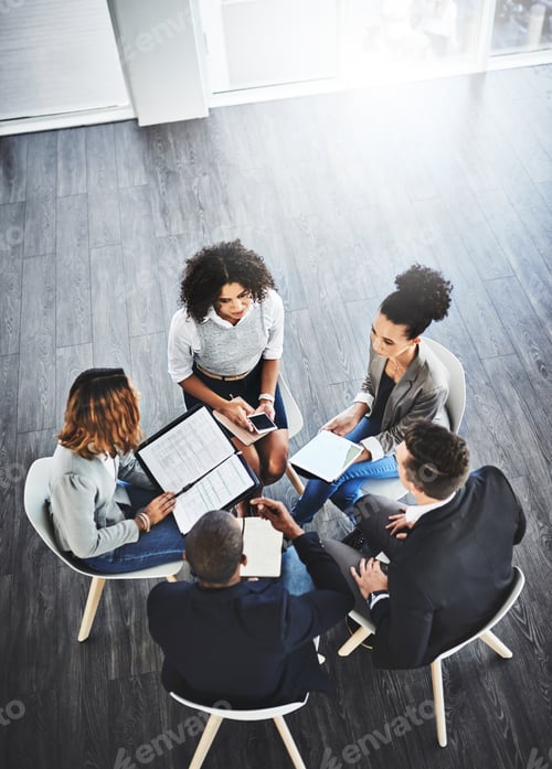Preview: High angle shot of a group of businesspeople having a discussion in an office
