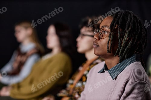 Preview: Young Adult Black Man Attending Presentation with Diverse Audience