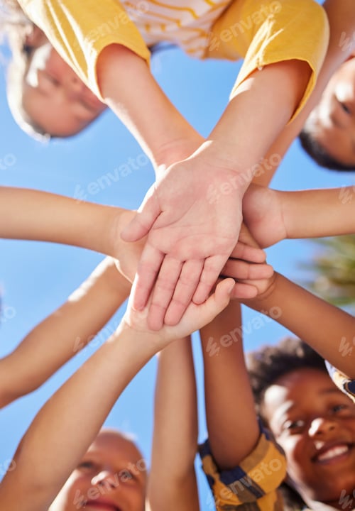 Preview: Shot of a group of kids stacking their hands on top of each other outside