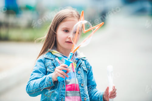 Preview: Girl making soap bubbles
