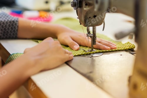 Preview: Young woman with sewing machine