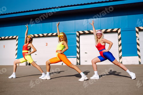 Preview: Beautiful women in swimsuits are dancing on beach. Fitness, training, aerobics and people concept.