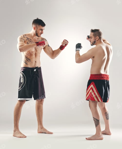 Preview: Who do you think will win. Full length shot of MMA two fighters ready to battle.