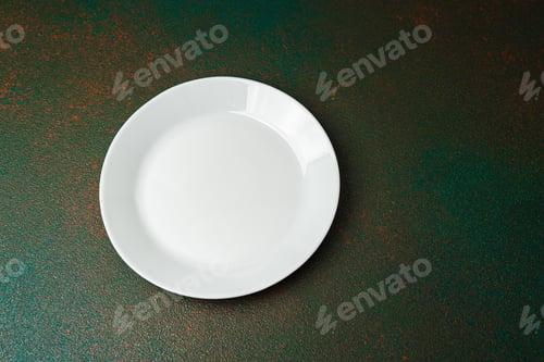 Preview: Empty white plate on textured green background with natural lighting display