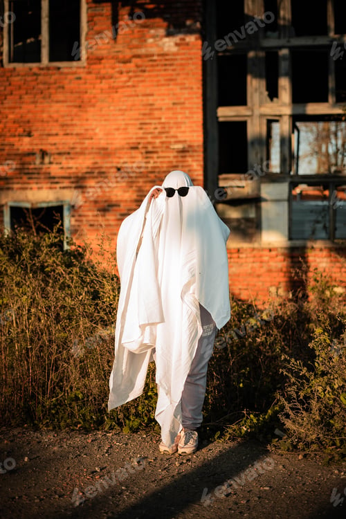 Preview: Celebrating halloween. Ghost Challenge 2021. Spooky trend season. A man in a ghost costume made from