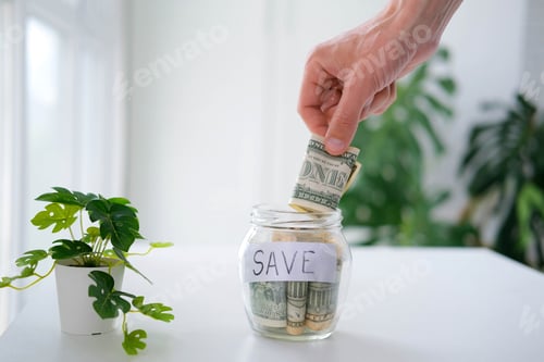 Preview: Savings jar with money and plant on table
