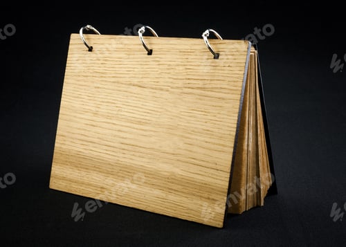Preview: Wooden notebook on a dark background.