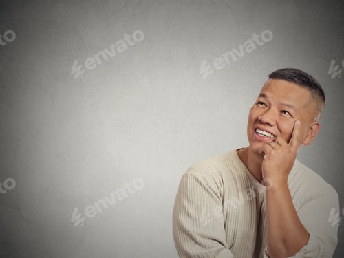 Preview: Portrait Happy Handsome Man Thinking Looking Up Isolated Grey Wall Background With Copy Space