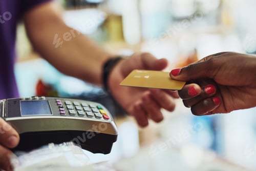 Preview: Cropped shot of an unrecognizable customer making payment in a store