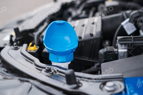 Preview: Blue cap of the reservoir for windshield washer fluid, close up