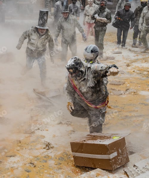 Preview: Ibi, Spain - December, 28 2018: People throwing eggs and flour at each other