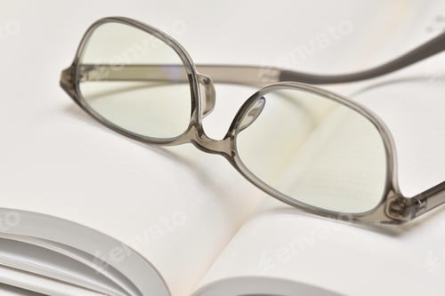 Preview: Eyeglasses Resting on Open Book Pages