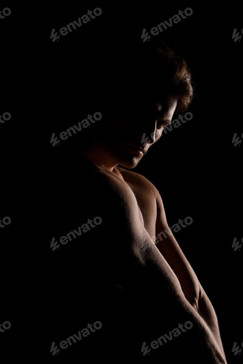 Preview: handsome muscular man posing isolated on black