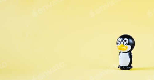 Preview: toy penguin on a yellow background. south pole animals. kids skills development.