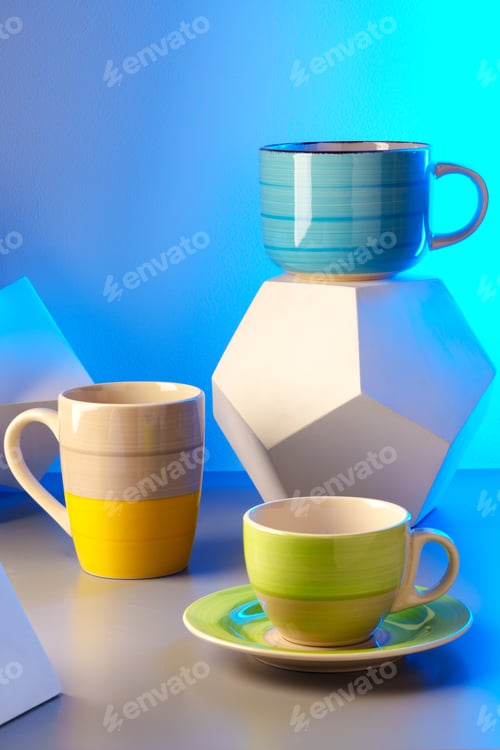 Preview: Colorful clay ceramic cups on gray background