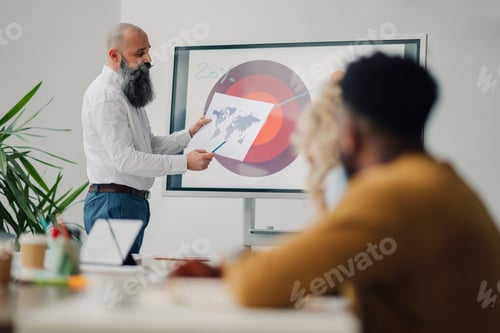 Preview: Marketing manager explaining global strategy during a business meeting