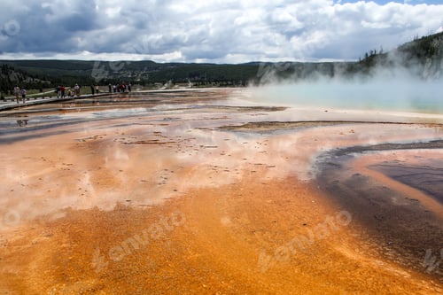 Preview: Yellowstone National Park landscape with active geyser steam and mountains in background