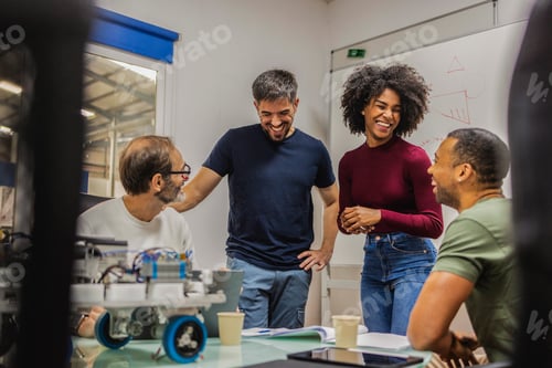 Preview: Robotics engineers having fun developing a new automated machine