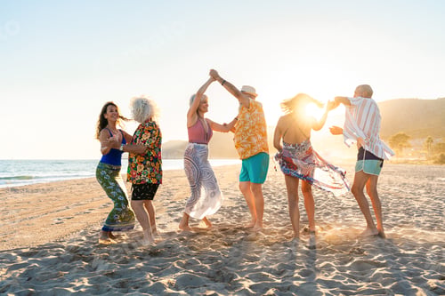 Preview: Happy group of senior friends bonding at the beach during summertime