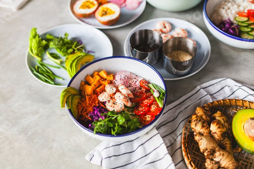 Preview: Poke bowl with shrimp prepared by the chef containing white rice, mango, avocado, tomato, etc.