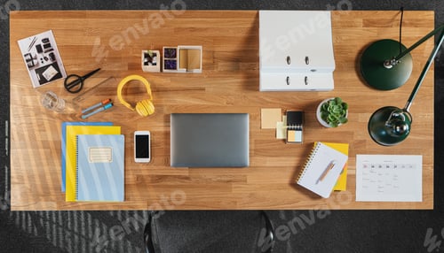 Preview: Top view of desk with computer, tablet and paperwork in home office.