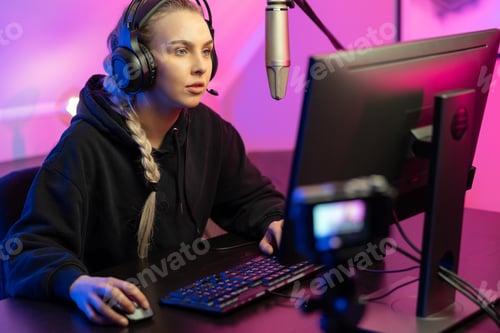 Preview: Professional e-sport gamer girl streaming and plays online video game on PC