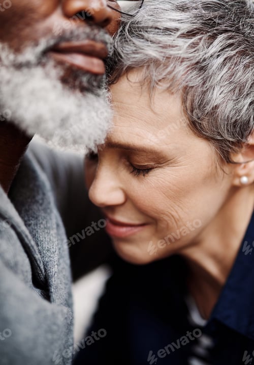 Preview: Eternal love. Closeup up shot of an affectionate senior couple relaxing on the sofa at home.
